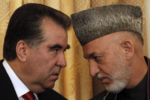 Afghan President Hamid Karzai talks to the President of Tajikistan Emomalii Rahmon in Kabul, Afghanistan, Oct. 25. Karzai told reporters Monday that once or twice a year Iran gives his office $700,000 to $975,000 for official presidential expenses. Allauddin Khan/AP Photo