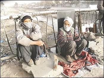 Two members of the Hazara ethnic minority rest between jobs pulling cargo carts in Kabul. Hazaras have long been relegated to menial jobs. (Pamela Constable)