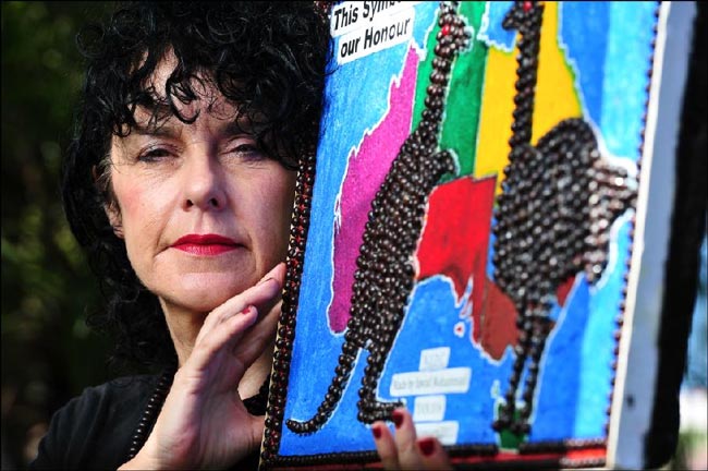 Curator of the Footprints of my Heart exhibition Vikki Reily with some of the artwork by asylum seekers that will be on display at the Darwin Supreme Court. Picture: MICHAEL FRANCHI