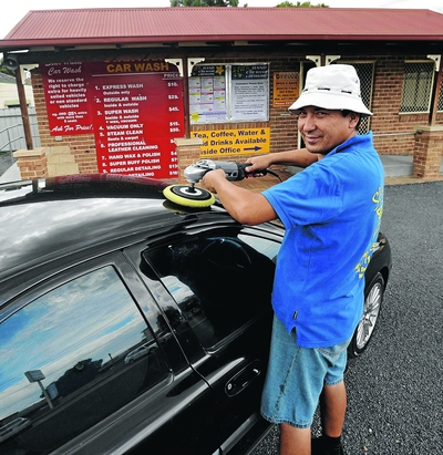 NEW LIFE: Ali Ramazani puts the finishing touches on a client's car. Picture: Les Smith